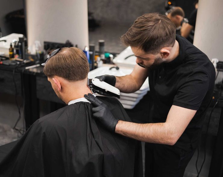 male-hairdresser-making-a-haircut-for-a-young-man-2022-02-17-20-02-40-utc.jpg