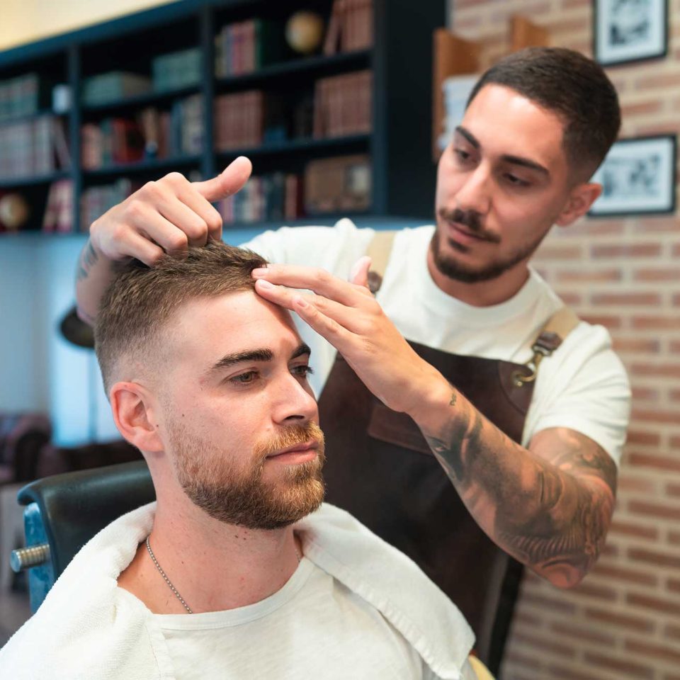 young-hairdresser-with-tattoos-styling-the-male-cu-2023-01-18-19-36-34-utc.jpg